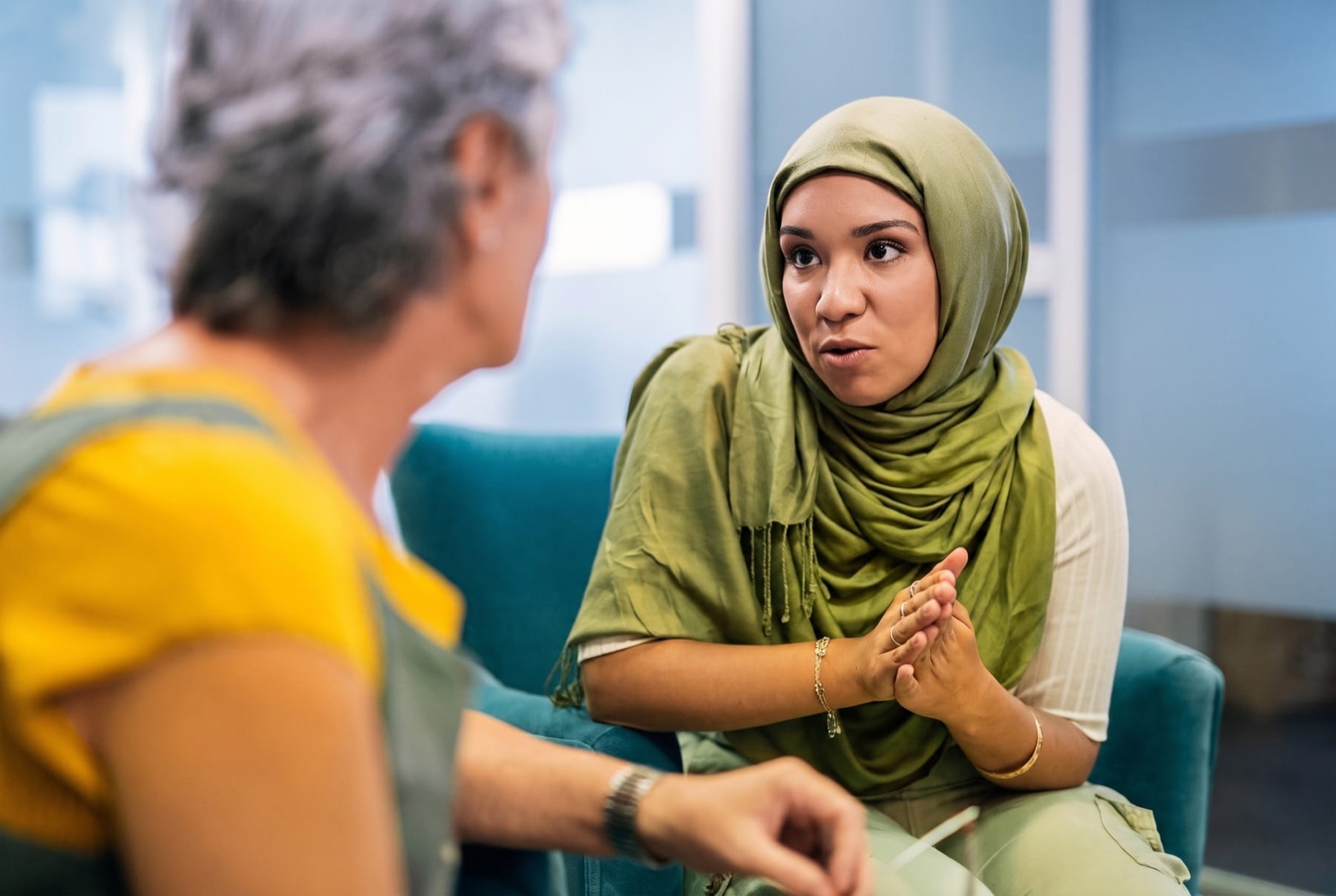 Two women in conversation in a consultation setting.